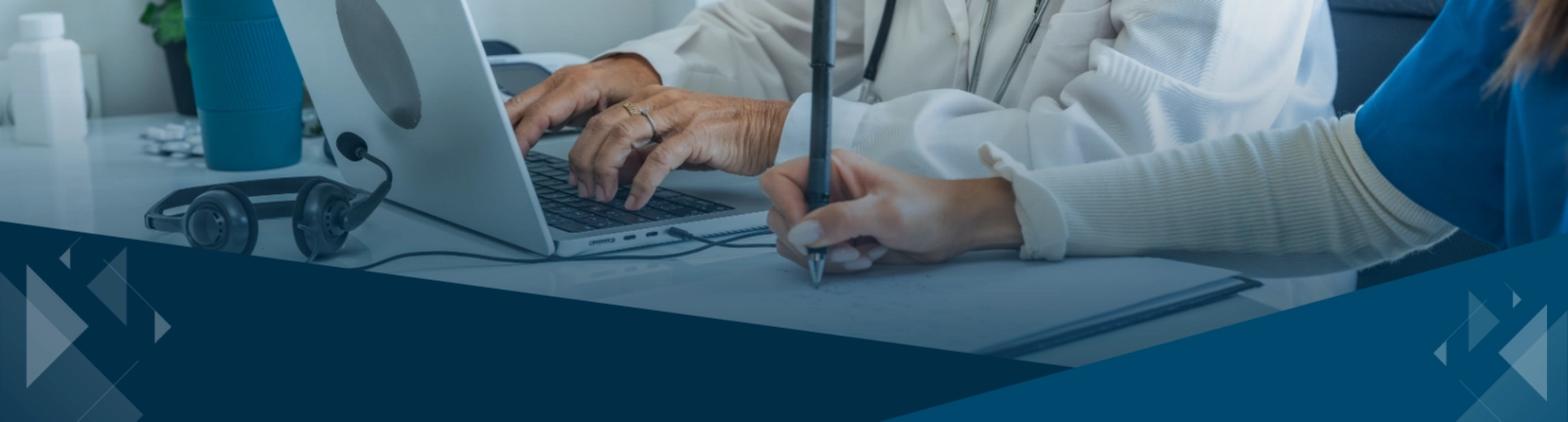 Medical staff collaborating with a laptop and written notes in a clinic setting